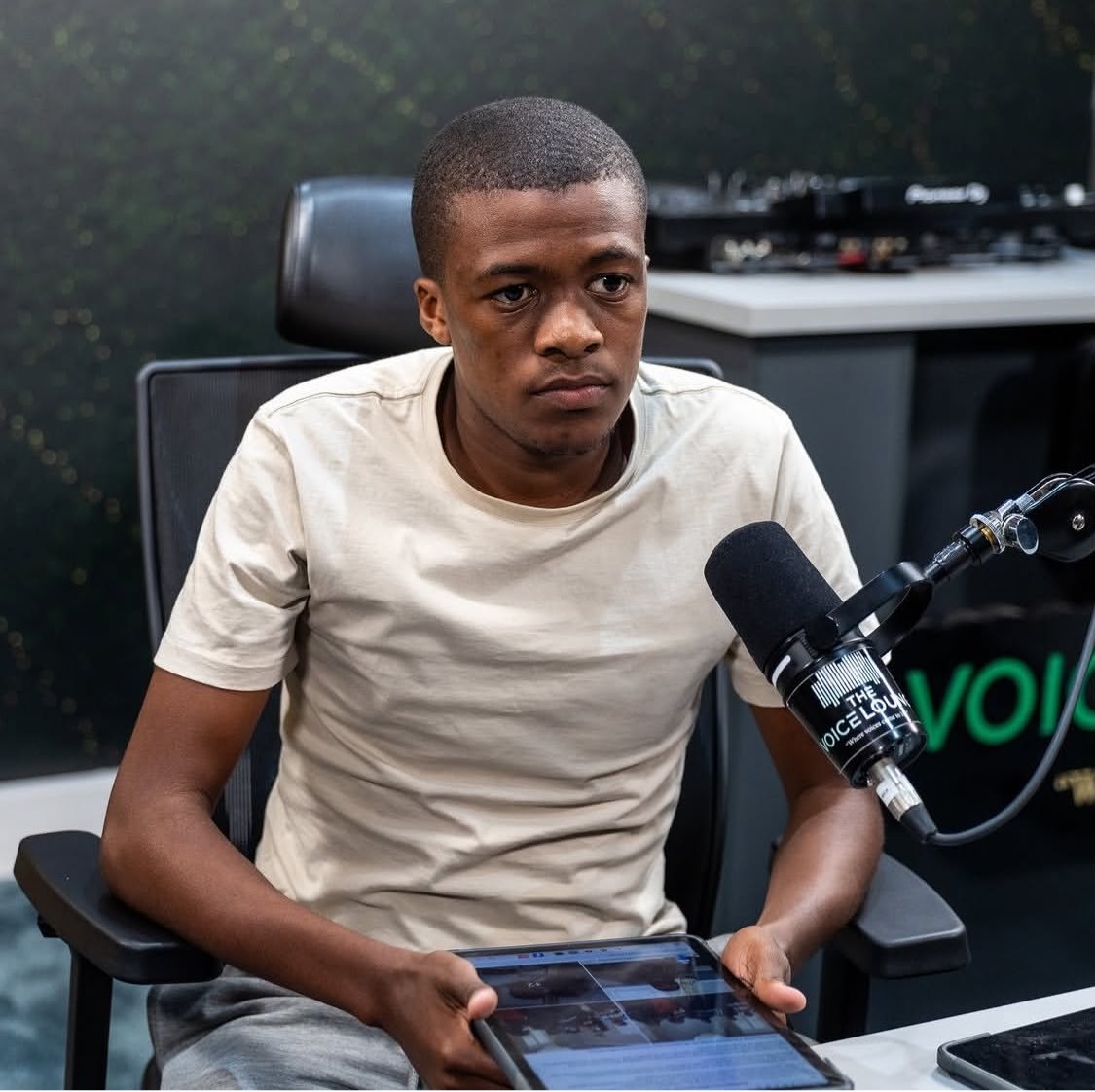 Cwenga Sihle Peter at a microphone during a studio discussion
